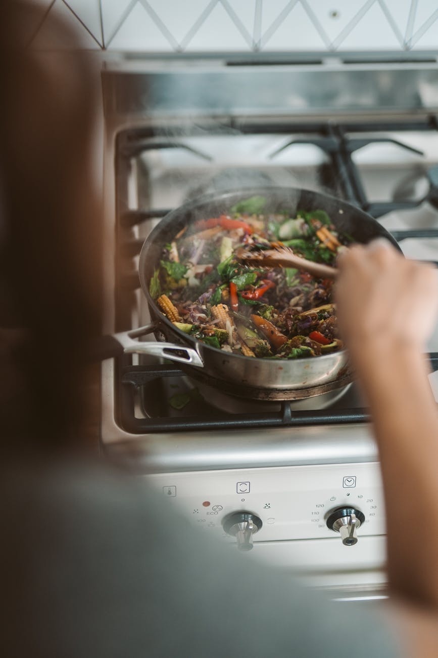 person cooking on black pan